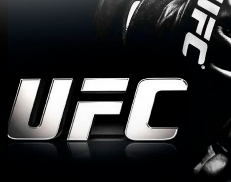 Логотип UFC на темном фоне. Часть боксерской перчатки видна справа, отображая спортивную тематику